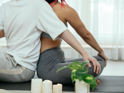 Soft light hitting a yoga practitioner's back.
